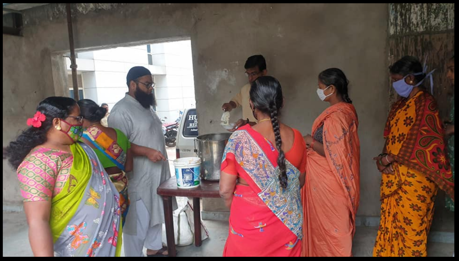 Volunteers serving meals at the new distribution venue